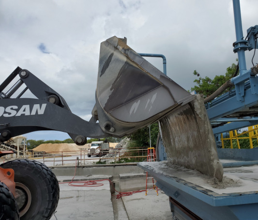 Loader dumping Yard Waste Into Redi-Wash System